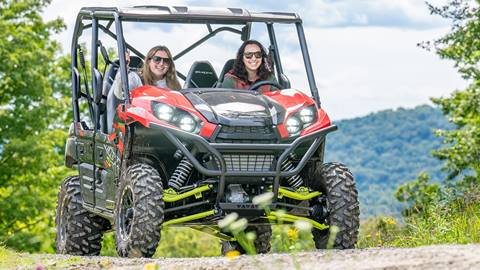 two riders smile mid-ride during a stratton resort utv tour across scenic alpine terrain