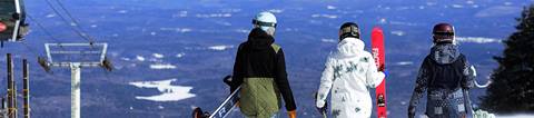 Group of three looking out over the slopes at Stratton